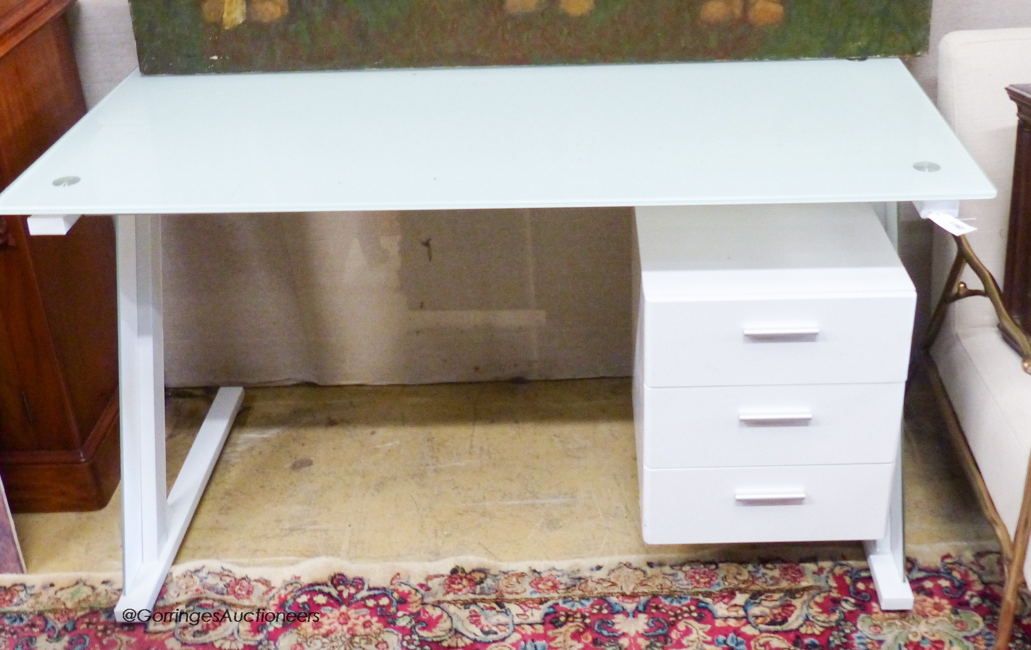 A contemporary white lacquer glass top kneehole desk, length 140cm, depth 70cm, height 75cm